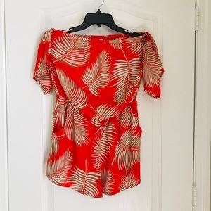orange/red romper with floral pattern